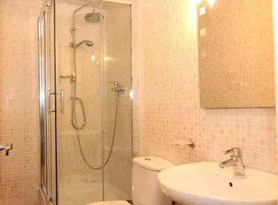 a bathroom with a shower and a toilet and a sink at MUNTANYA - Apartments & one with Terrace next to Sagrada Familia in Barcelona