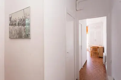 a hallway with white walls and a painting on a wall at Apart Cozy On The Front Line, Liliane in Sitges