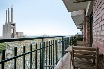 a balcony with a bench and a view of the city at Alcam Sant Adria in Sant Adria de Besos