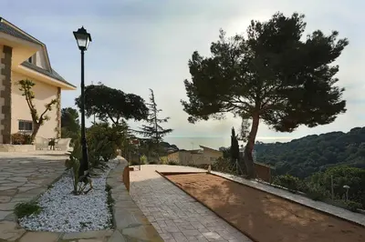 a street light next to a house with a tree at Homestay Villa Estrella - Costa Brava in Calella