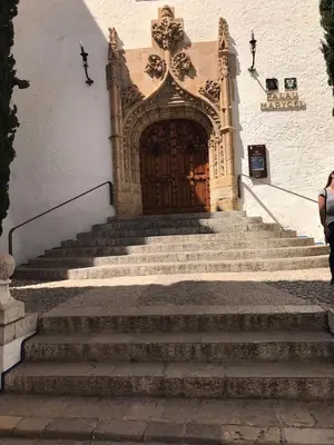 a set of stairs leading to a large wooden door at CIM Apartments in Olivella