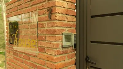 a brick wall next to a door with a vent at CIM Apartments in Olivella