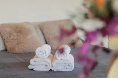 a group of towels on a table with a stuffed animal at CIM Apartments in Olivella