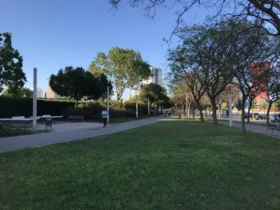 a park with a person riding a bike on a sidewalk at Habitación Amaya 1 in Las Corts