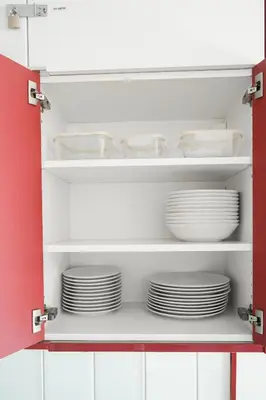 a cupboard filled with white plates and bowls at Loft Ponent, Sant Pol de Mar in San Pol de Mar