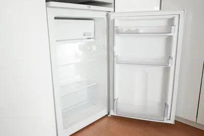 an empty refrigerator with its doors open in a kitchen at Loft Ponent, Sant Pol de Mar in San Pol de Mar
