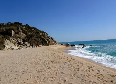 a beach with footprints in the sand and the ocean at Loft Ponent, Sant Pol de Mar in San Pol de Mar