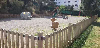 a playground with toys in a park with a fence at Apart.3 habit.mar-mont. AC-Terraza-ascensor-parking in Calella