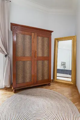 a wooden cabinet in a room with a mirror at Art House Station Rocafort ´Sant Antoni´ in Barcelona