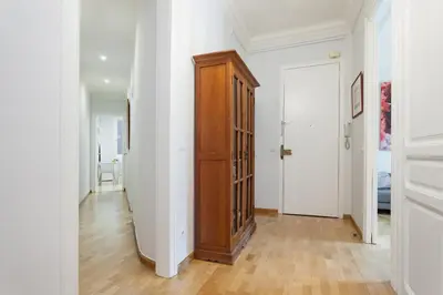 a hallway with a wooden cabinet in a white room at Art House Station Rocafort ´Sant Antoni´ in Barcelona
