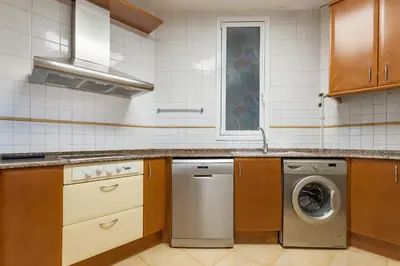 a kitchen with a washer and a washing machine at Art House Station Rocafort ´Sant Antoni´ in Barcelona