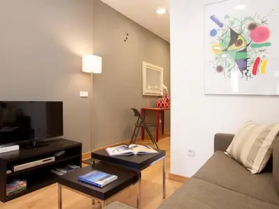 a living room with a couch and a tv at Sagrada Familia in Barcelona