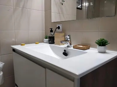 a bathroom with a white sink in a room at Bonavista Bright Sea View Studio with Balcony in Calella
