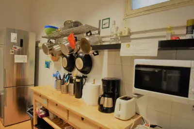 a kitchen with a counter with pots and pans at Fabrizzios Terrace Hostel in Barcelona