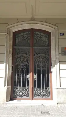 a large door to a building with wrought iron at Fabrizzios Terrace Hostel in Barcelona