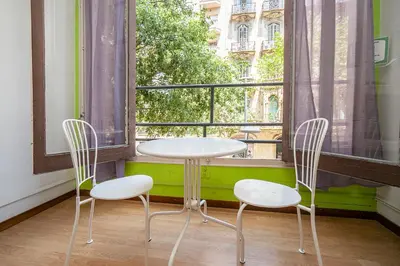 a table and two chairs in front of a window at Fabrizzios Terrace Hostel in Barcelona