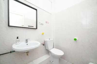 a bathroom with a sink and a toilet and a mirror at Fabrizzios Terrace Hostel in Barcelona