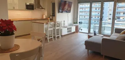a kitchen and living room with a couch and a table at Apartamento Bea Beach in Badalona