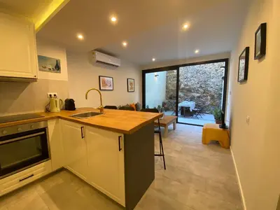 a kitchen with a sink and a counter top at Beautiful apartment 5 minutes walk to the beach in Caldes d'Estrac