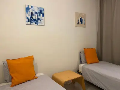 a small room with two beds and a table at Beautiful apartment 5 minutes walk to the beach in Caldes d'Estrac