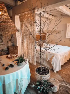 a room with a table with a tree in it at Suite con Burbuja in Canyelles