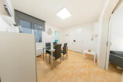a living room with a table and a dining room at Ahllenrock Cornellà - Parking Gratis- Cerca BCN in Cornellà de Llobregat