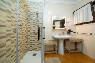 a bathroom with a sink and a shower at 8 to 10 Sleeps Private Pool Villa & BBQ Near Barcelona in Rocafort