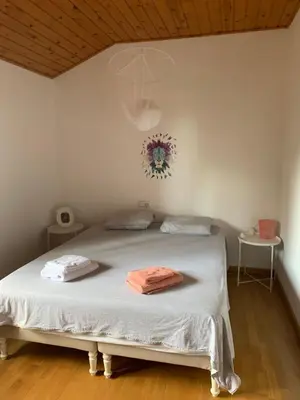 a bedroom with a bed with two towels on it at Casa Feliz in Sant Cebrià de Vallalta