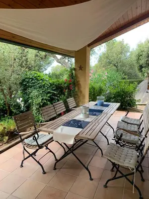 a table and chairs sitting on a patio at Casa Feliz in Sant Cebrià de Vallalta
