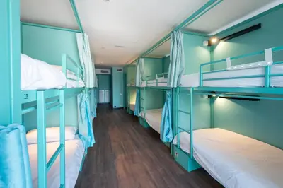 a room with four bunk beds with blue walls at Hostelle - Women only hostel Barcelona in Barcelona