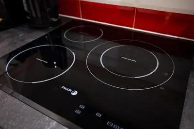 a black stove top oven with three rings on it at Stay U-nique Apartments Radas in Barcelona