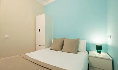 a bedroom with a white bed and a white cabinet at Stay U-nique Apartments Radas in Barcelona