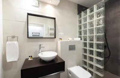 a bathroom with a sink and a mirror and a toilet at Stay U-nique Apartments Radas in Barcelona