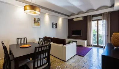 a living room with a table and a dining room at Stay U-nique Apartments Radas in Barcelona