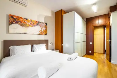a bedroom with a white bed and a painting on the wall at Stay U-nique Apartments Marina in Barcelona