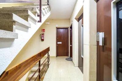 a hallway with stairs and a wooden door at Stay U-nique Apartments Marina in Barcelona