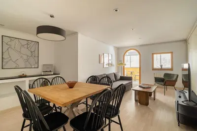a dining room and living room with a table and chairs at Stay U-nique Apartments Aribau in Barcelona