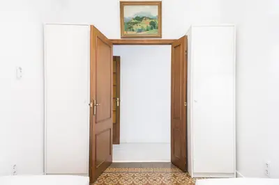 an open door in a room with a picture on the wall at Spacious 3 bed Apt in the heart of Sant Antoni, Barcelona in Barcelona