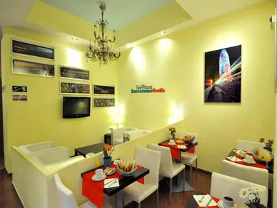 a restaurant with two tables and chairs and a chandelier at BARCELONA GOTIC Guesthouse in Barcelona