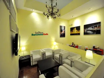 a living room with white furniture and a chandelier at BARCELONA GOTIC Guesthouse in Barcelona