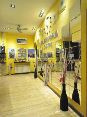 a store with vases on the floor and a yellow wall at BARCELONA GOTIC Guesthouse in Barcelona