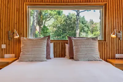 a bedroom with a bed with a large window at Villa Can Duarry - Barcelona Country House 1 in Premia de Dalt