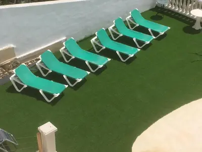 a group of chairs sitting on top of a pool at Villa Paradise , playa privada a 10 minutos de Sitges in Sant Pere de Ribes