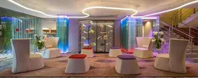 a room with white chairs and tables and lights at Hotel Sansi Barcelona in Barcelona