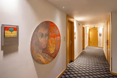 a large painting of a man on a wall in a hallway at Hotel Sansi Barcelona in Barcelona