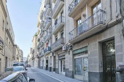a city street with cars parked on the side of buildings at Apartamento Alejandro en BCN in Barcelona
