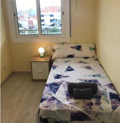 a bedroom with a bed and a window at Cerdanyola centro in Cerdanyola del Valles