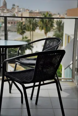 two chairs and a table on a balcony at Apartaments Can Negret in Sitges