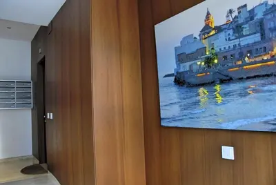 a tv hanging on a wall in a room at Apartaments Can Negret in Sitges