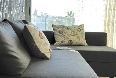 a couch with pillows on it in a living room at Apartaments Can Negret in Sitges